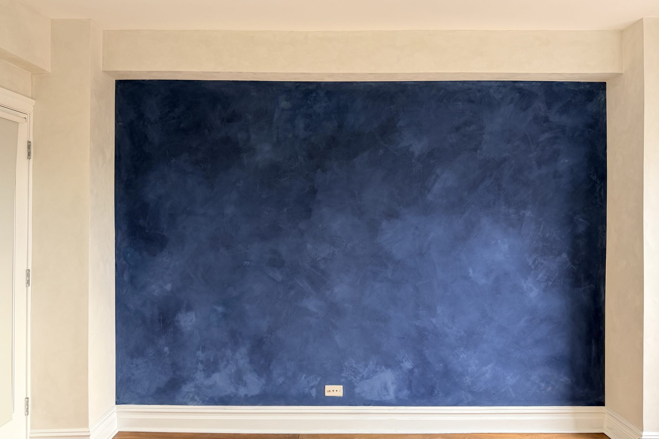 Navy hand-applied limewash accent wall in a West Village residence
